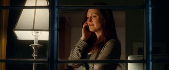 Movie still from “Crazy, Stupid, Love.” (2011), directed by Glenn Ficarra – A woman talking on a cell phone while standing in front of a window; Medium shot, Low angle