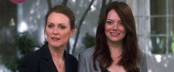 Movie still from “Crazy, Stupid, Love.” (2011), directed by Glenn Ficarra – Two women standing next to each other in front of trees; Close Up shot, Over the shoulder angle