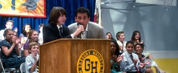 Movie still from “Crazy, Stupid, Love.” (2011), directed by Glenn Ficarra – A man and a boy are speaking at a podium; Medium shot, Low angle