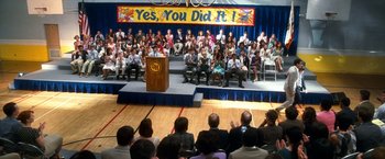 Movie still from “Crazy, Stupid, Love.” (2011), directed by Glenn Ficarra – A crowd of people sitting in front of a podium; Extreme Wide shot, High angle