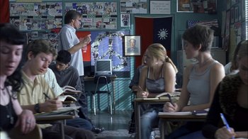 Movie still from “Crazy/Beautiful” (2001), directed by John Stockwell – A group of people sitting at desks in a classroom; Wide shot, Over the shoulder angle