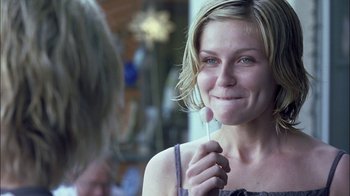 Movie still from “Crazy/Beautiful” (2001), directed by John Stockwell – A woman holding a tooth brush in her mouth; Close Up shot, Over the shoulder angle