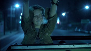 Movie still from “Crazy/Beautiful” (2001), directed by John Stockwell – A young woman is waving her arms in the air; Medium shot, Low angle