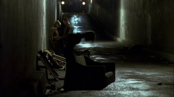 Movie still from “Crazy/Beautiful” (2001), directed by John Stockwell – Two people sitting on a bench in an alley; Wide shot, High angle
