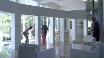 Movie still from “Crazy/Beautiful” (2001), directed by John Stockwell – Two men and a little girl in a living room; Wide shot, High angle