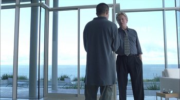 Movie still from “Crazy/Beautiful” (2001), directed by John Stockwell – Two men standing in front of a large window; Medium shot, Low angle