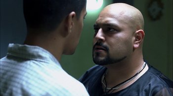 Movie still from “Crazy/Beautiful” (2001), directed by John Stockwell – A man stares at a mirror while another man looks on; Close Up shot, Over the shoulder angle