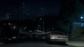 Movie still from “Crazy/Beautiful” (2001), directed by John Stockwell – Cars are parked on the side of the road at night; Extreme Wide shot, High angle