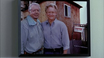 Movie still from “Crazy/Beautiful” (2001), directed by John Stockwell – Two men standing next to each other in front of a building; Medium shot, Low angle