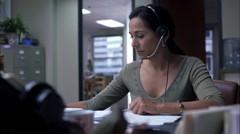 Movie still from “Crazy/Beautiful” (2001), directed by John Stockwell – A woman wearing a headset is sitting at a desk; Close Up shot, High angle