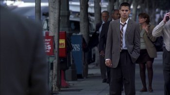 Movie still from “Crazy/Beautiful” (2001), directed by John Stockwell – A man in a suit and tie walking down a sidewalk; Wide shot, Low angle