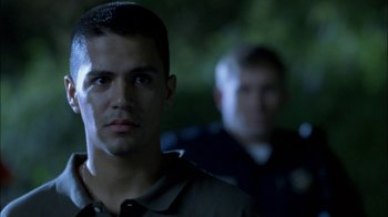 Movie still from “Crazy/Beautiful” (2001), directed by John Stockwell – Two police officers standing next to each other in the dark; Close Up shot, Over the shoulder angle
