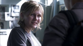 Movie still from “Crazy/Beautiful” (2001), directed by John Stockwell – A young woman sitting on a train looking at the camera; Close Up shot, Over the shoulder angle