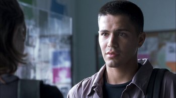 Movie still from “Crazy/Beautiful” (2001), directed by John Stockwell – A young man is standing in a room; Close Up shot, Over the shoulder angle