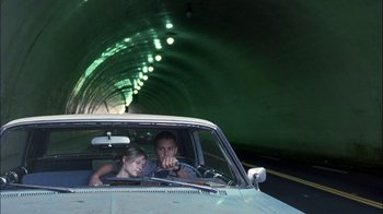Movie still from “Crazy/Beautiful” (2001), directed by John Stockwell – A man and a woman in the drivers seat of a car in a tunnel; Wide shot, Low angle