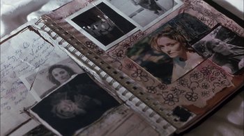 Movie still from “Crazy/Beautiful” (2001), directed by John Stockwell – An album with photos of a young woman on the cover; Extreme Close Up shot, Overhead angle