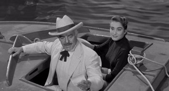 Movie still from “Creature from the Black Lagoon” (1954), directed by Jack Arnold – An older man and a young woman are in a boat; Medium shot, High angle