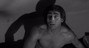 Movie still from “Creature from the Black Lagoon” (1954), directed by Jack Arnold – A shirtless man looking up at the ceiling; Close Up shot, High angle