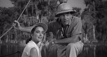 Movie still from “Creature from the Black Lagoon” (1954), directed by Jack Arnold – A man and a woman sitting next to each other on a boat; Medium shot, High angle