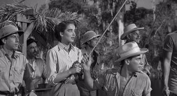 Movie still from “Creature from the Black Lagoon” (1954), directed by Jack Arnold – An old black and white photo of a woman holding a rope; Medium shot, Low angle