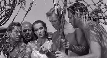 Movie still from “Creature from the Black Lagoon” (1954), directed by Jack Arnold – A black and white photo of a group of men and a woman; Medium shot, Low angle