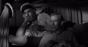 Movie still from “Creature from the Black Lagoon” (1954), directed by Jack Arnold – A black - and - white photo of two men sitting next to each other; Medium shot, High angle