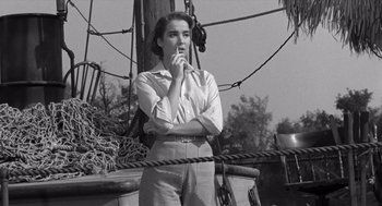 Movie still from “Creature from the Black Lagoon” (1954), directed by Jack Arnold – Black and white photograph of a woman on a boat; Medium shot, High angle