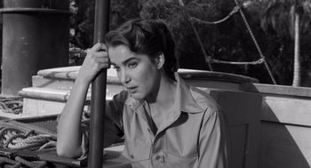 Movie still from “Creature from the Black Lagoon” (1954), directed by Jack Arnold – Black and white photograph of a woman leaning on a pole; Close Up shot, High angle