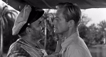Movie still from “Creature from the Black Lagoon” (1954), directed by Jack Arnold – Two men are facing each other in a black and white photo; Close Up shot, Over the shoulder angle