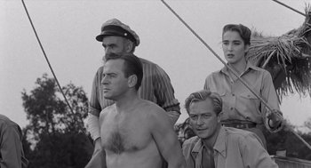 Movie still from “Creature from the Black Lagoon” (1954), directed by Jack Arnold – A group of people standing next to each other on a boat; Medium shot, Low angle