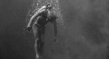 Movie still from “Creature from the Black Lagoon” (1954), directed by Jack Arnold – A man is swimming in the water; Wide shot, Low angle