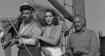 Movie still from “Creature from the Black Lagoon” (1954), directed by Jack Arnold – An old black and white photo of a woman and two men; Medium shot, Low angle