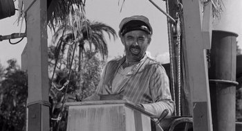 Movie still from “Creature from the Black Lagoon” (1954), directed by Jack Arnold – An older man wearing a sailor's hat and a striped shirt; Medium shot, Low angle