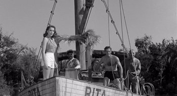 Movie still from “Creature from the Black Lagoon” (1954), directed by Jack Arnold – A woman standing on top of a boat next to two men; Wide shot, Low angle