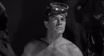 Movie still from “Creature from the Black Lagoon” (1954), directed by Jack Arnold – A man with a bowl on his head; Close Up shot, High angle