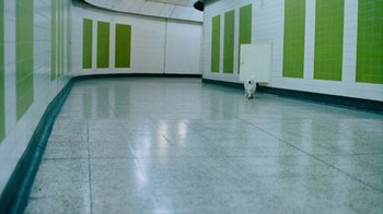 Movie still from “Creep” (2004), directed by Christopher Smith – A white cat is walking in a hallway; Extreme Wide shot, High angle