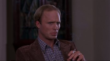 Movie still from “Creepshow” (1982), directed by George A. Romero – A person smoking a cigarette; Close Up shot, High angle