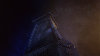 Movie still from “Creepshow” (1982), directed by George A. Romero – A dark picture of a building with a sky background; Wide shot, Low angle