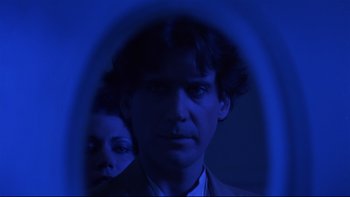 Movie still from “Creepshow” (1982), directed by George A. Romero – A man and a woman are reflected in a mirror; Close Up shot, Low angle