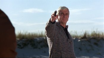 Movie still from “Creepshow” (1982), directed by George A. Romero – An older man holding a gun in his right hand; Medium shot, Low angle