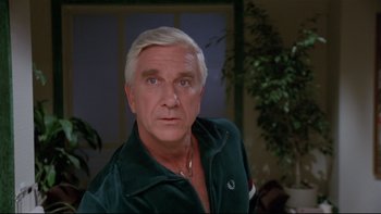 Movie still from “Creepshow” (1982), directed by George A. Romero – An older man wearing a green shirt and looking at the camera; Close Up shot, Low angle