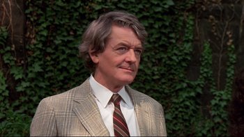 Movie still from “Creepshow” (1982), directed by George A. Romero – A person wearing a suit and tie; Close Up shot, Low angle