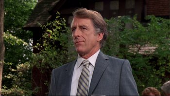 Movie still from “Creepshow” (1982), directed by George A. Romero – A person wearing a suit and tie; Close Up shot, Low angle