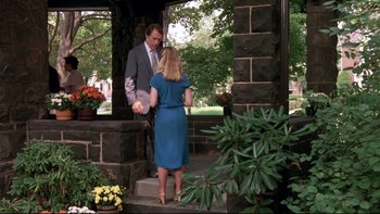 Movie still from “Creepshow” (1982), directed by George A. Romero – A man and a woman standing on steps in front of a building; Wide shot, Over the shoulder angle
