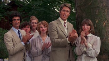 Movie still from “Creepshow” (1982), directed by George A. Romero – A group of people standing next to each other clapping; Medium shot, Low angle
