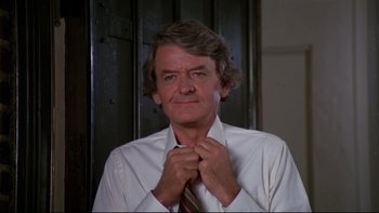 Movie still from “Creepshow” (1982), directed by George A. Romero – A person tying a tie; Close Up shot, Low angle