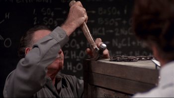 Movie still from “Creepshow” (1982), directed by George A. Romero – An old man is hammering something into a box; Close Up shot, High angle