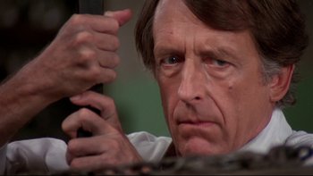 Movie still from “Creepshow” (1982), directed by George A. Romero – An older man is looking at the camera; Close Up shot, Low angle