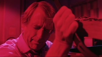 Movie still from “Creepshow” (1982), directed by George A. Romero – A man holding a cell phone up to his head; Close Up shot, Low angle