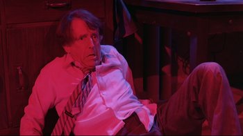 Movie still from “Creepshow” (1982), directed by George A. Romero – A man in a white dress shirt and a tie; Medium shot, High angle